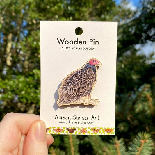 A wooden pin of a turkey vulture