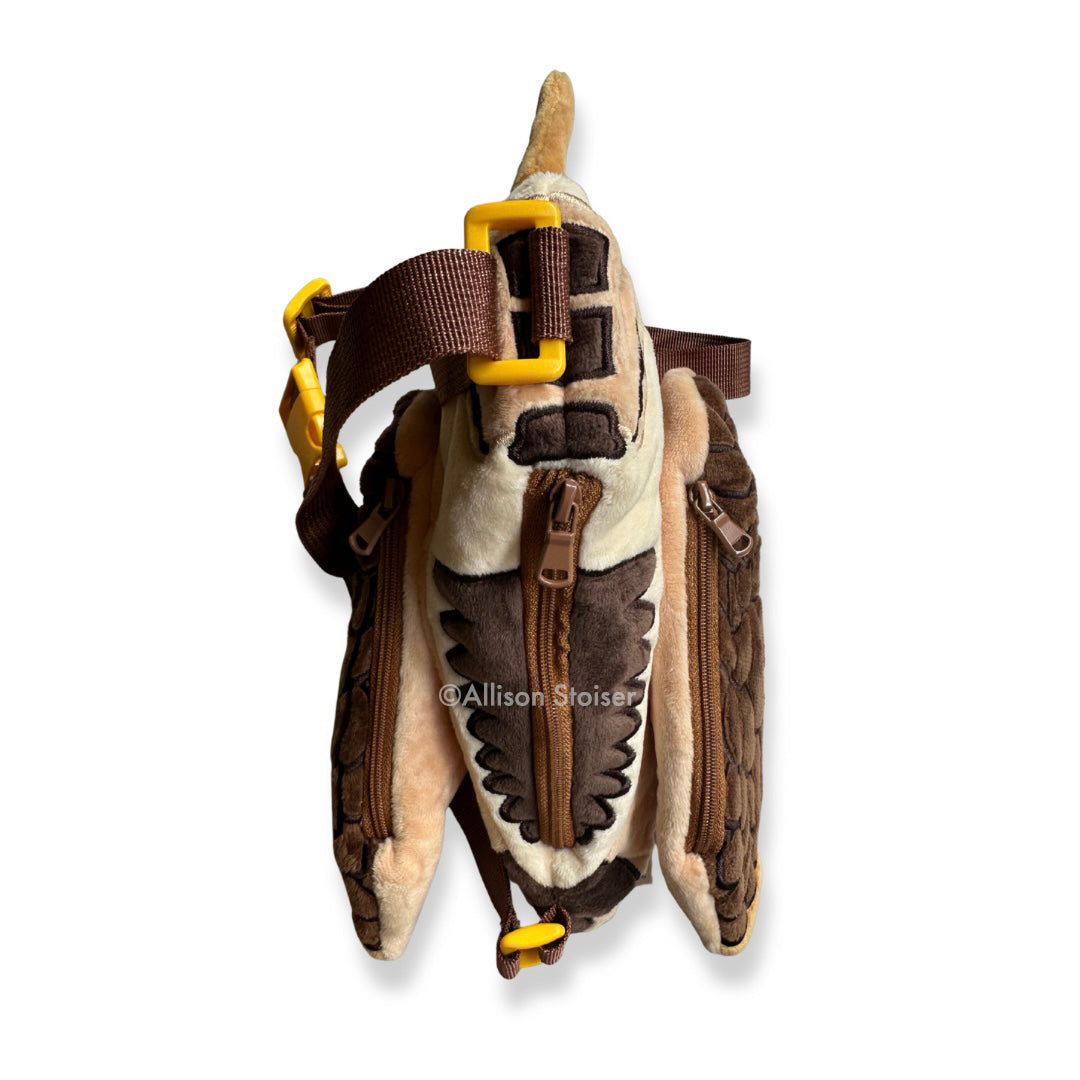 A top-down view of a plush woodcock bag.