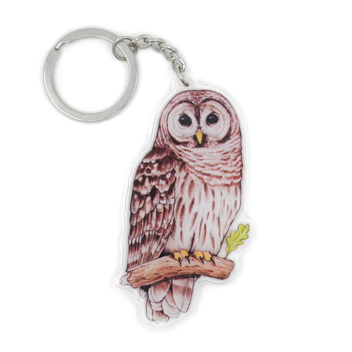 A keychain of a barred owl on a white background.