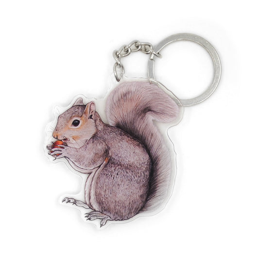 A keychain of an eastern gray squirrel on a white background.