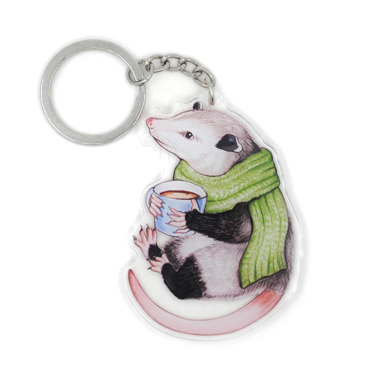 A keychain of an opossum in a scarf with a mug of hot chocolate on a white background.