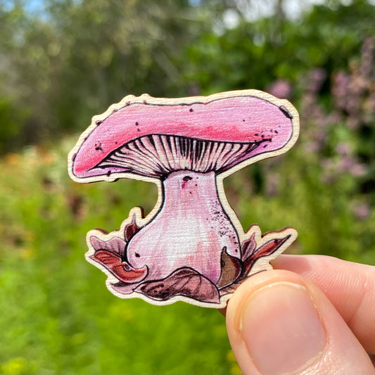 A sustainably sourced pin featuring an illustration of a wood blewit mushroom