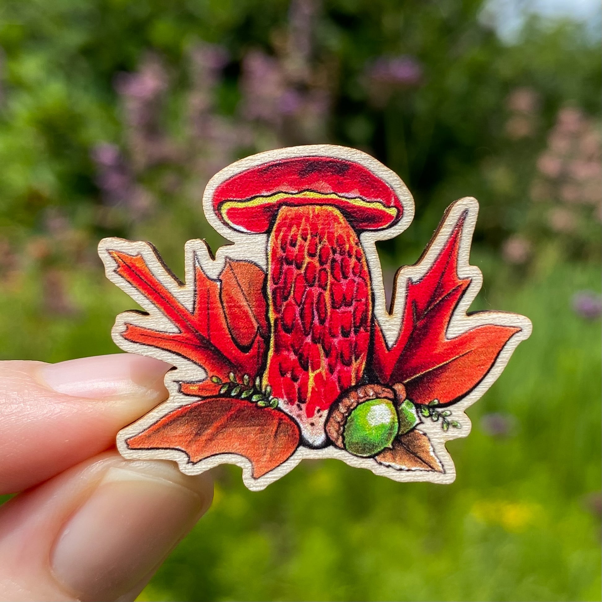 A sustainably sourced pin featuring an illustration of a frost bolete mushroom