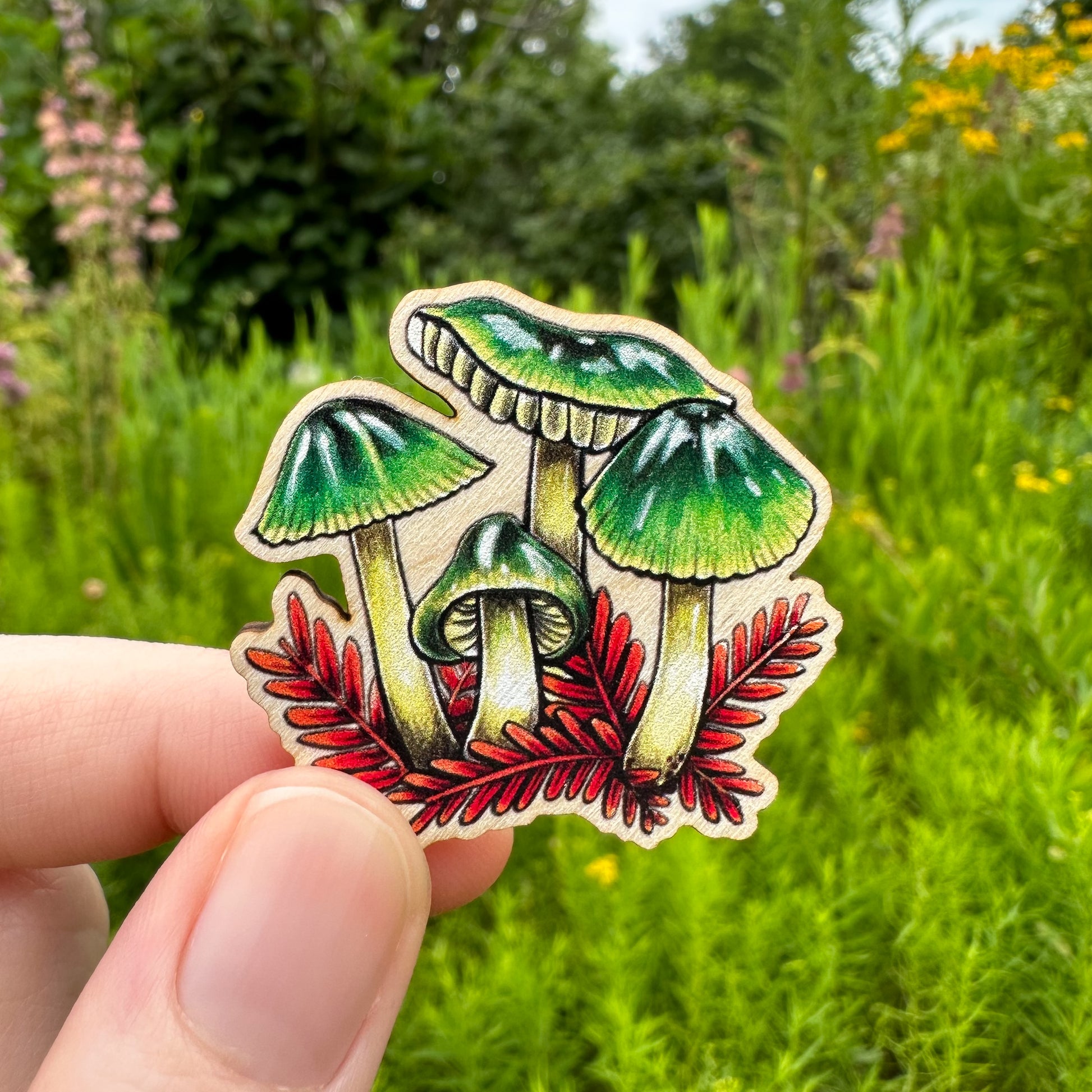 A sustainably sourced pin featuring an illustration of a parrot waxcap mushroom