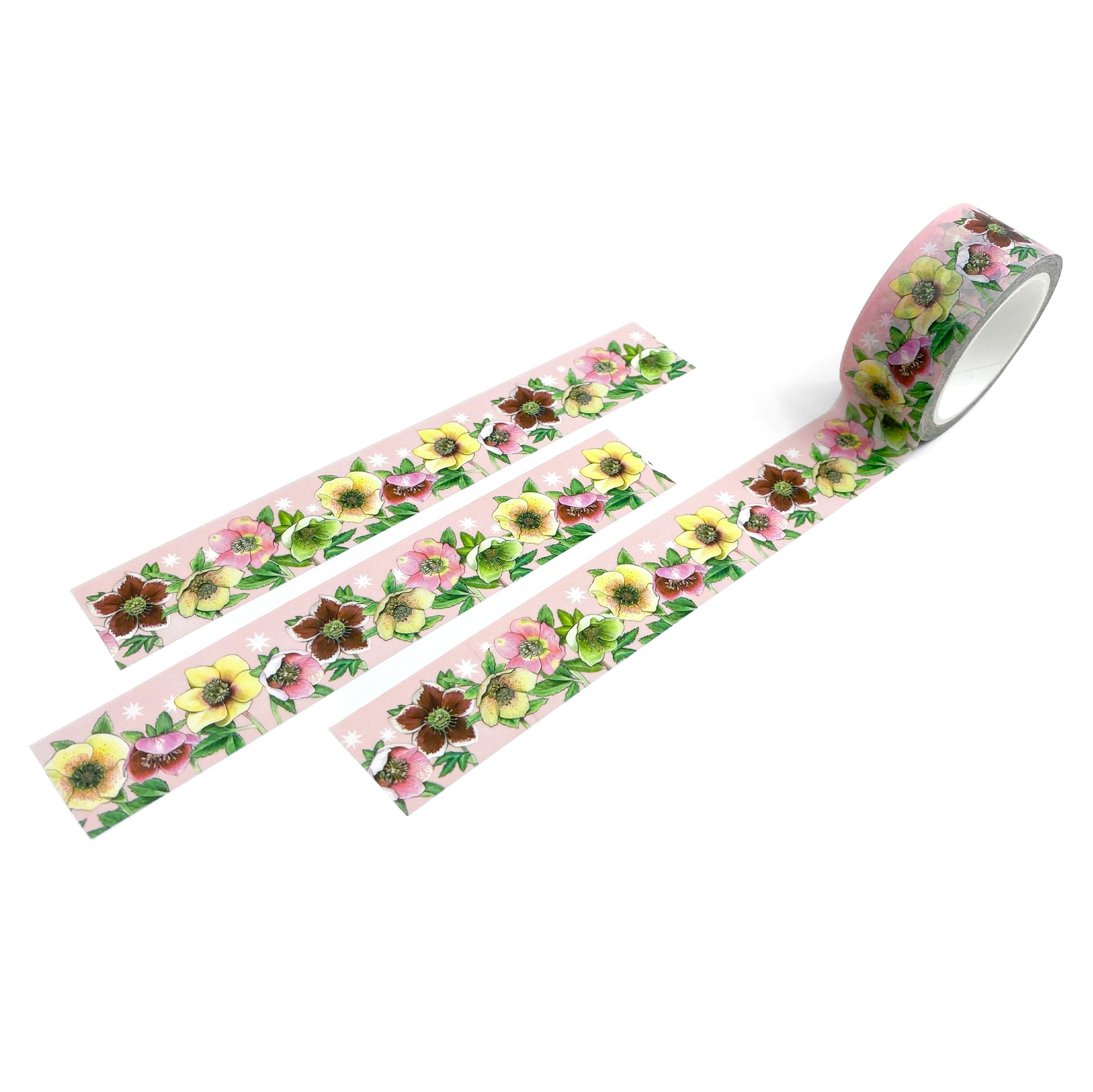 Washi tape with lenten roses/hellebores on a pink starry background swatched on a white background.