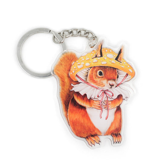 A keychain of a red squirrel in a mushroom hat on a white background.