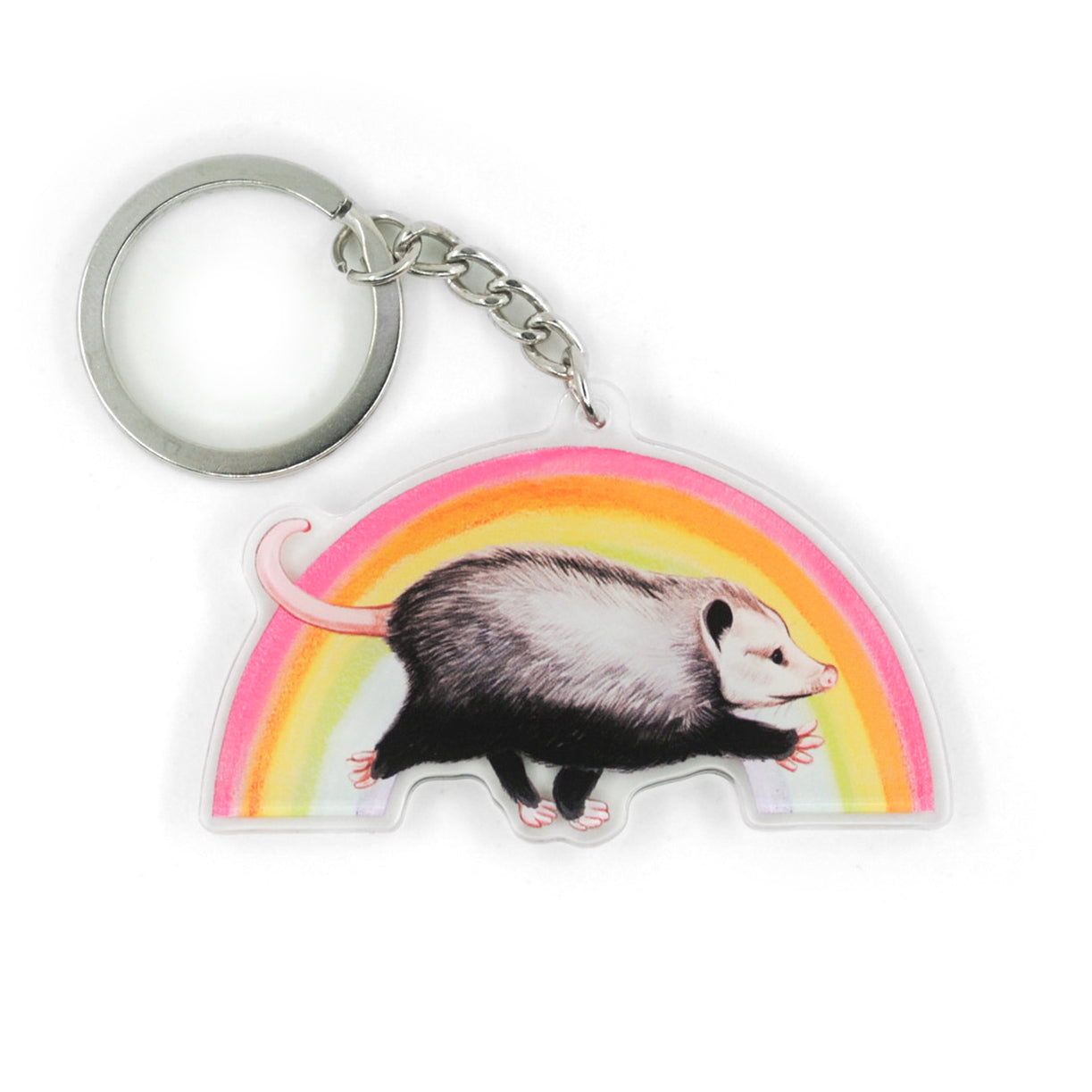 A keychain featuring a opossum marching in front of a rainbow