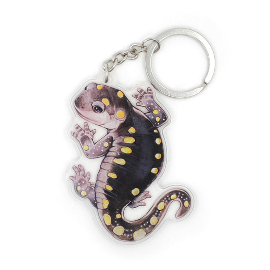 A keychain of a yellow-spotted salamander on a white background.