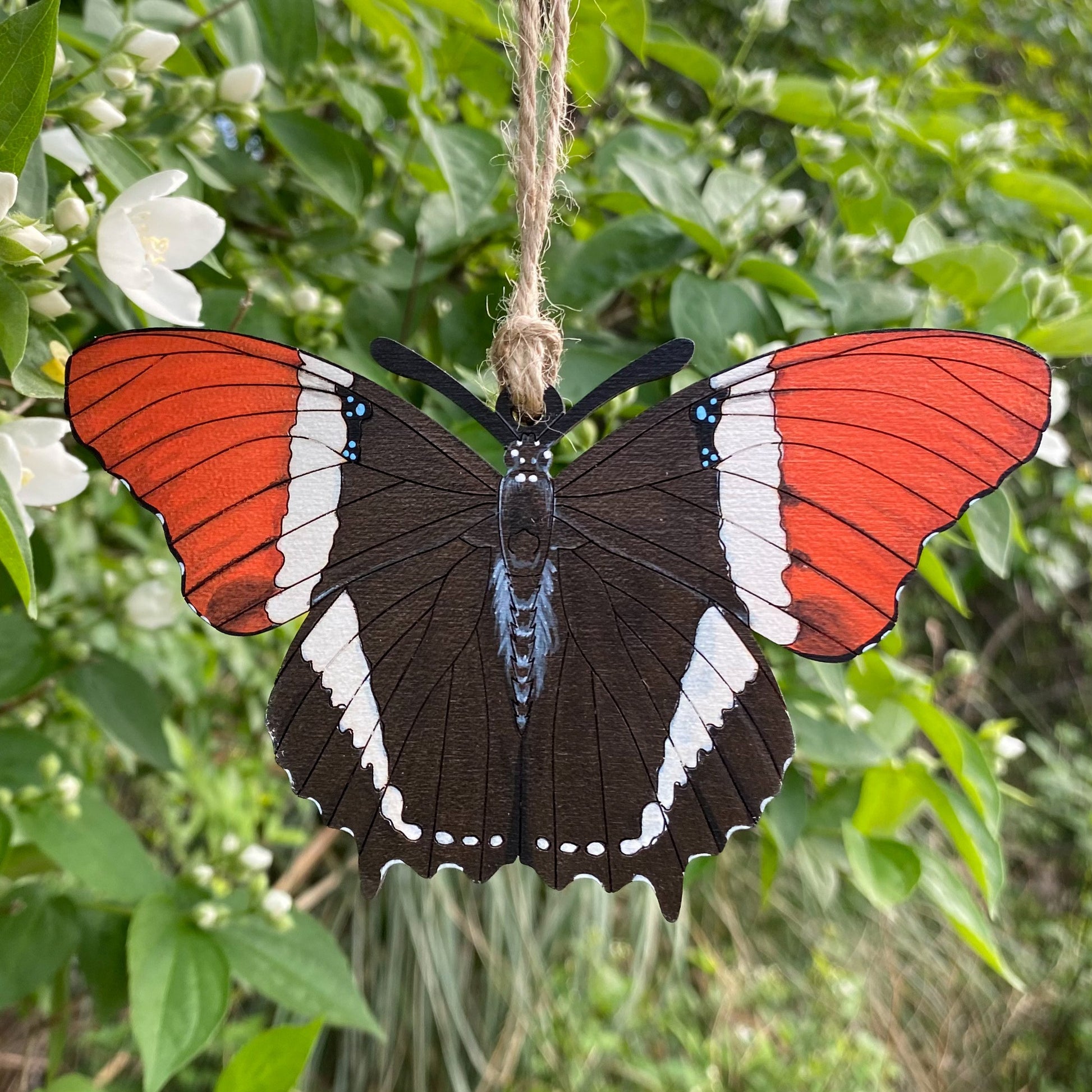 A hand-painted ornament of a rusty-tipped page butterfly