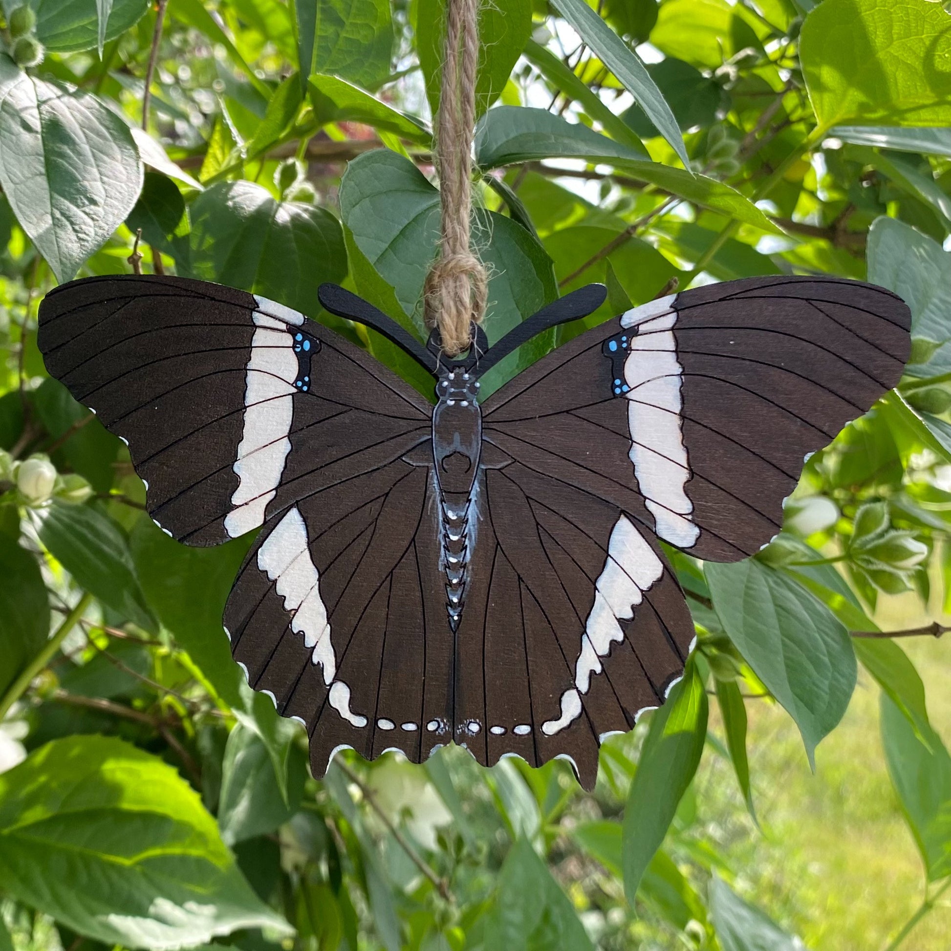 A hand-painted ornament of a rusty-tipped page butterfly