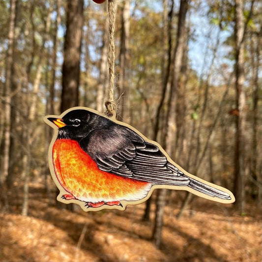 A wood print ornament featuring an illustration of an American robin