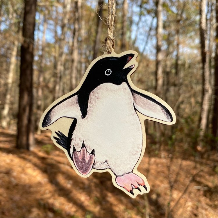 A wood print ornament featuring an illustration of an Adelie penguin