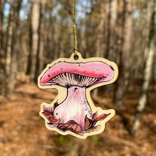 A wood print ornament featuring an illustration of a wood blewit mushroom