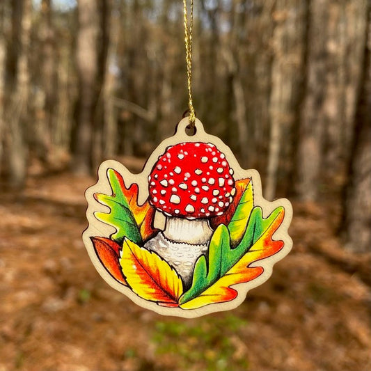 A wood print ornament featuring an illustration of a fly agaric mushroom