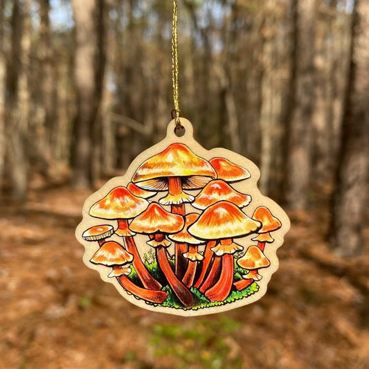 A wood print ornament featuring an illustration of a honey mushroom