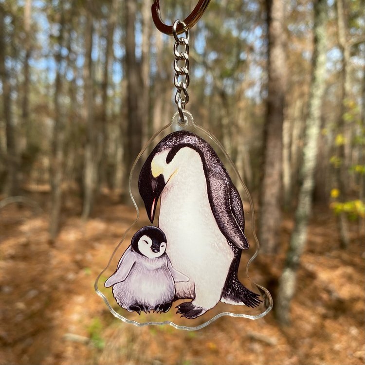 A keychain featuring an emperor penguin and its chick