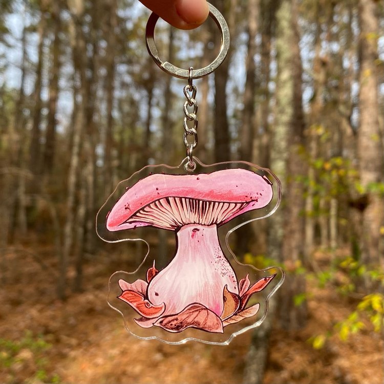 A keychain featuring a wood blewit mushroom