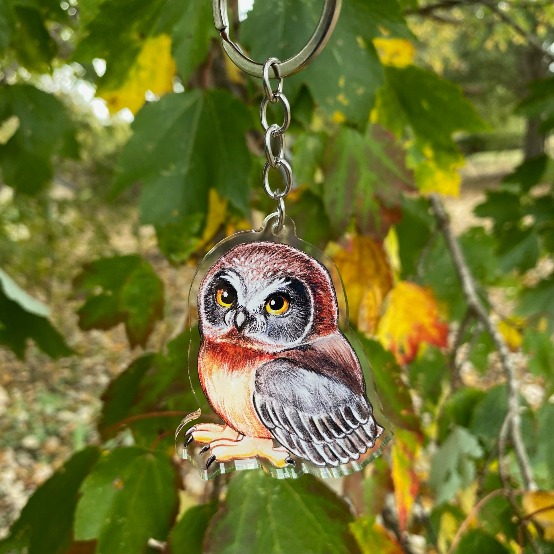 A keychain featuring an illustration of a raccoon