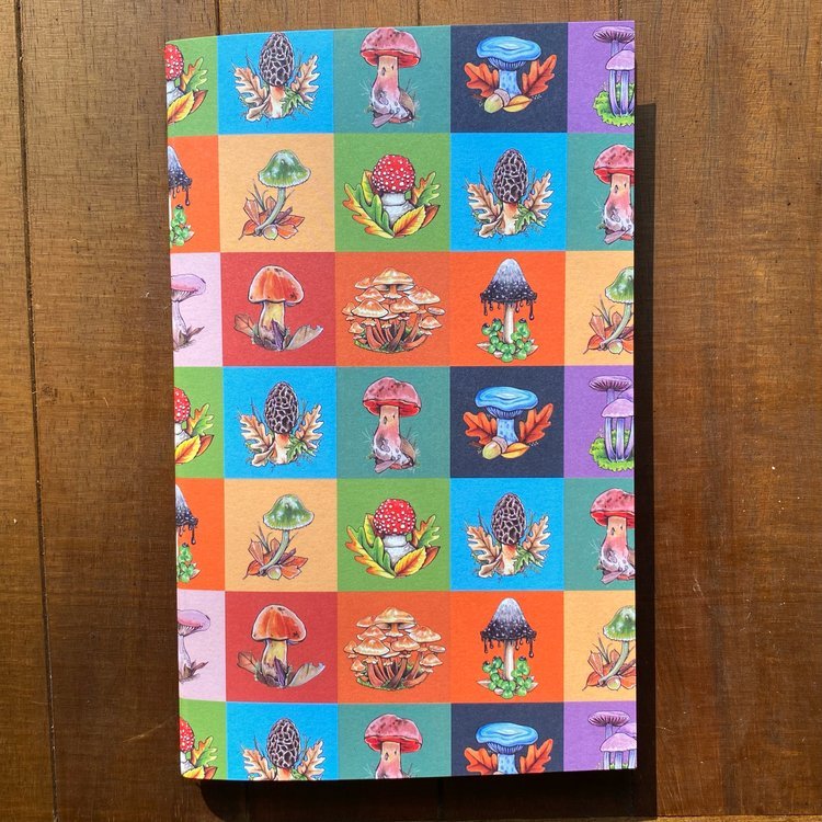 A handmade notebook featuring a color block pattern of mushrooms